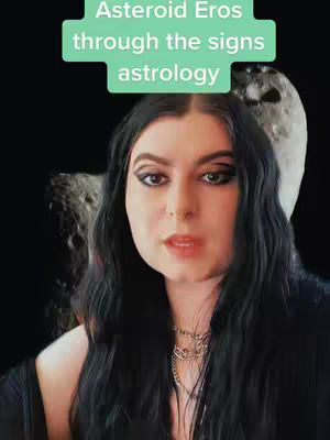 The image features a woman with long, dark hair, wearing a necklace and a black top. The background is a dark, out-of-focus scene with a partial moon visible. Overlayed on the image is a green rectangle with white text. The woman is looking directly at the camera.