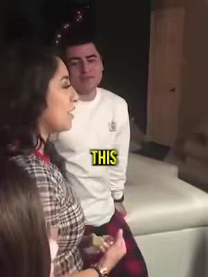 A woman is talking, with a man standing behind her. The text overlay says "THIS."
