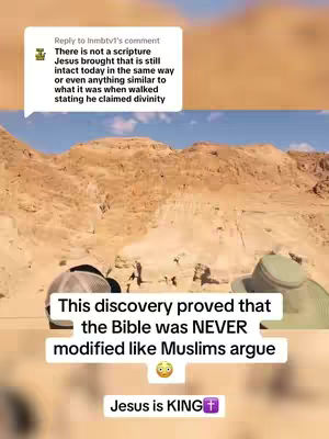 The image shows a desert landscape with rugged, brown terrain. A comment bubble with text mentioning scripture and Jesus is in the top left of the image. The overlay has text stating a discovery proved that the Bible was never modified and Jesus is KING.