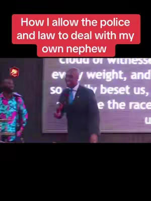 The image shows a man speaking in a church setting, with text overlayed on the top. He is wearing a black suit and a blue tie. Text on the banner reads "How I allow the police and law to deal with my own nephew". Another person is seen partially in the background and blurred, wearing a floral shirt and a microphone.
