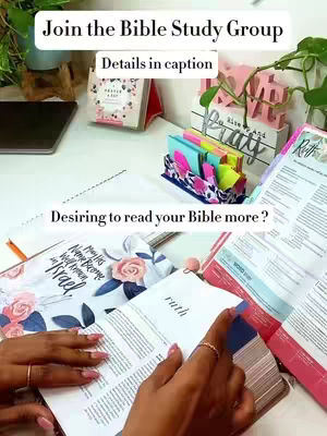 The image shows a well-lit, inviting workspace. In the foreground, the hands of a person with painted nails and rings are visible as they open a Bible to the book of Ruth. The pages are open on a white surface surrounded by items like a devotional book, colorful sticky notes in a holder, and a small sign that reads 'Pray' and 'Rise And'. The background includes a laptop, a small plant, and a white surface, suggesting a cozy, organized study or desk setup. The main text elements 'Join the Bible Study Group' and 'Desiring to read your Bible more?' are overlaid on the image.