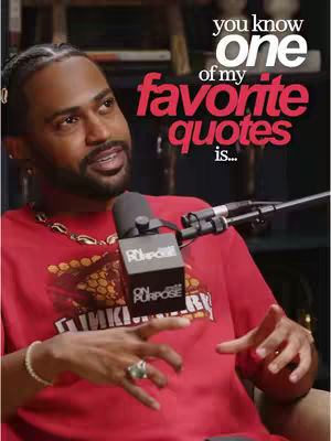 The cover image features Big Sean, a Black man, seated in what appears to be a studio setting. He's wearing a red t-shirt with graphic, a gold chain, and a bracelet. A microphone is positioned in front of him, and the background is blurred, hinting at bookshelves. Overlaid on the image is white and red text that reads, 'you know ONE of my favorite quotes is...'