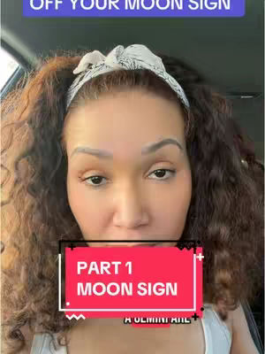 A woman with curly brown hair and a white headband is in the center of the frame, appearing to be indoors. In the foreground, a red rectangle with white text overlies a portion of her face and hair. The background is blurred, suggesting a vehicle interior due to the visible side window and door frame.