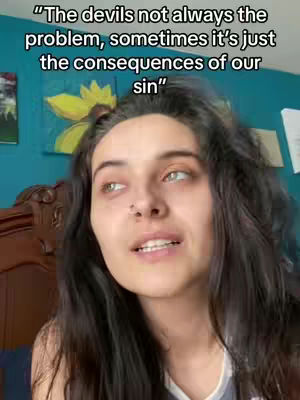A woman with long dark hair is looking up and to the side with a concerned look on her face while speaking. Above her is text overlayed, and the background is a room with a painting and a wooden bed.