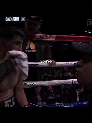 The video cover shows a boxing ring with a boxer in the left foreground, holding a towel to his face. Behind him, a coach or corner man stands with his hands on the ropes. Above the boxing ring are the words, "Golden Boy". In the background, there are other people watching the boxing match. The color scheme is dim and muted, reflecting the lighting of a boxing ring.