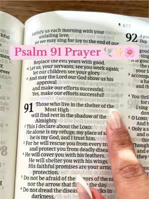 The cover image shows an open Bible with the text of Psalm 91 highlighted. A pink banner with the words "Psalm 91 Prayer" is overlaid on the text, along with some decorative elements. A hand with a neatly manicured nail is pointing at the text, emphasizing the passage.