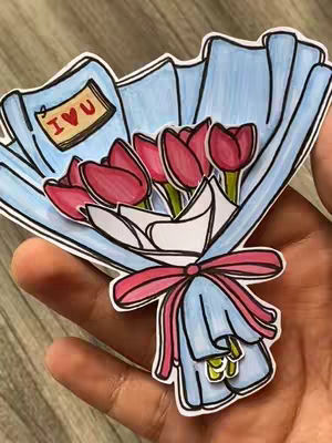 A hand holds a colorful papercraft bouquet of tulips. The bouquet is wrapped in light blue paper and tied with a pink ribbon. The tulips are red and pink The background is a light gray and the whole image is outlined in black.