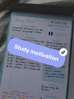 A close-up shot of a study plan written on a notepad. A purple banner with the text "Study motivation" overlays part of the plan. The notepad is resting on a patterned surface.