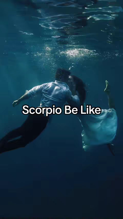 An underwater scene with two figures, a man and a woman, embracing. A text overlay reads ''Scorpio Be Like''. The scene is primarily blue.