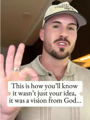A man with a beard and a baseball cap smiles, holding up his hand with a ring on his finger and giving an 'okay' gesture, with a text overlay about recognizing God's vision.
