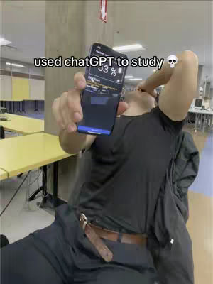 The cover image shows a person, presumably the creator, holding a smartphone, partially obscuring their face. The phone's screen displays a percentage, likely a study or test score. The person is dressed in black attire, and the background indicates a study or work environment, with tables and a blurred background.