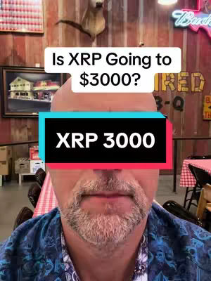 A selfie-style shot featuring a man with a short beard and a patterned blue shirt. The background includes a wooden wall with various decorations, including a framed picture and a deer head mount. Overlaid on the man's face is a text box with the questions ''Is XRP Going to $3000?'', and below that ''XRP 3000'' in bold white letters against a black and cyan background.
