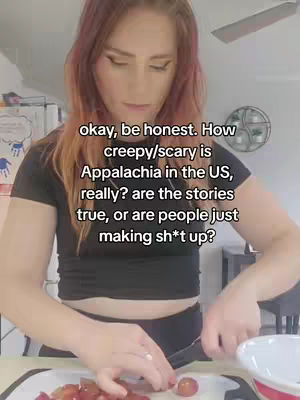 A woman with red hair prepares grapes in a kitchen, with text overlayed asking if the stories about Appalachia are true or just made up.
