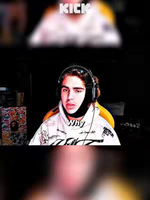 The image is a selfie-style photo of a person with dark hair wearing a black fabric around their neck. The person is in front of what appears to be a gaming setup. There is text overlayed that says "Why," and "KICK" in a higher layer.