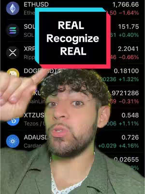 A man with a beard is pointing at a screen displaying cryptocurrency data. The background is a black interface with various cryptocurrency details, including price changes, names, and symbols. Overlayed prominently is a red and blue text box that reads "REAL Recognize REAL". The man is looking directly at the camera, with a raised eyebrow and open mouth.
