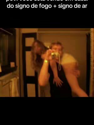 The cover image shows a man carrying a woman on his back in what appears to be a bathroom. The man is holding a camera and taking a selfie. The woman appears to be taking a picture of her own reflection in the mirror behind them. The lighting is warm, and the scene is slightly out of focus, giving it a casual and intimate feel.