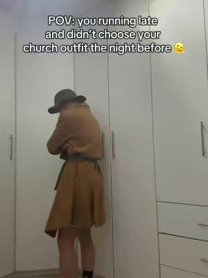 A person stands in front of a set of white closet doors, dressed in a brown outfit wearing a hat. The person appears to be getting dressed, with the text overlay conveying a relateable mood due to a church outfit not being chosen the night before