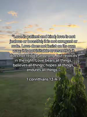 A vertical video cover image shows a serene outdoor scene bathed in the warm hues of a sunset or sunrise. The sky transitions from soft blues to vibrant oranges and yellows as it meets the greenery. In the center, a block of text is overlaid with a scripture from the Bible. At the bottom, there is a text which shows the citation of the scripture. The backdrop includes a field, trees, and distant structures, suggesting a sense of peace. The overall composition is calming and inspirational, with the text serving as the central focus.