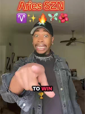 A man in a denim jacket points towards the viewer; text overlays the image with zodiac and spring themes. The background is a blurred domestic interior.
