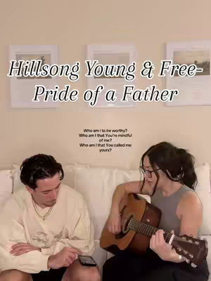 A couple sits on a couch, the woman playing an acoustic guitar, while the man looks at his phone. Text overlays the image mentioning Hillsong and a song title. The background features framed pictures.