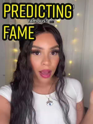 The cover image shows a woman with long, dark wavy hair, a white top, and a necklace with an eye pendant. The text overlay says "PREDICTING" in a yellow outlined font above "FAME" in the same style, with a question mark. The woman is looking at the camera with her mouth open.