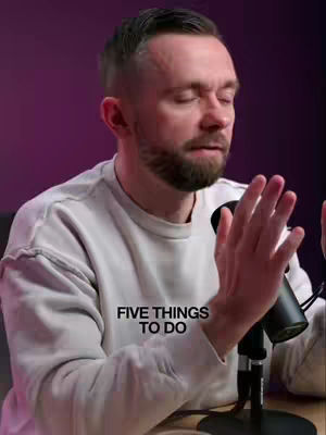 A man with a beard is sitting in front of a microphone. The background is a gradient of purple and the man wears a white sweater. The text 'FIVE THINGS TO DO' is super imposed over the image.