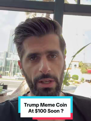 A man with dark hair and a beard looks directly at the camera. A text overlay at the bottom reads 'Trump Meme Coin At $100 Soon ?' The background includes a window with a view of an urban environment.