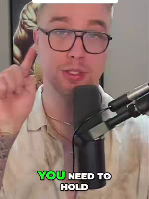 A man wearing glasses is speaking into a microphone. Text overlayed over the image reads, You need to hold.