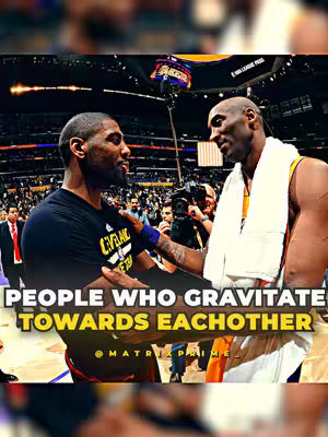An image of two famous basketball players, Kyrie Irving and Kobe Bryant, in a close interaction on a basketball court. The background is blurred, with a crowd of people and the bright lights of the arena visible. The players are in the center, Kobe with his arm around Irving's shoulder.