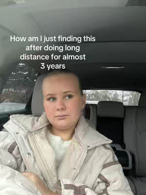 A woman in a car, looking thoughtfully ahead with a text overlay.