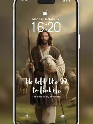 The image is a phone screen displaying a religious-themed digital artwork. In the center, Jesus is depicted holding a lamb, with a halo and wearing a robe. The background shows a cloudy sky and a flock of sheep. Text overlays read: 'He left the 99 to find me' and 'The Lord is my shepherd,' positioned below Jesus. The phone's interface is visible, including time and date indicators.