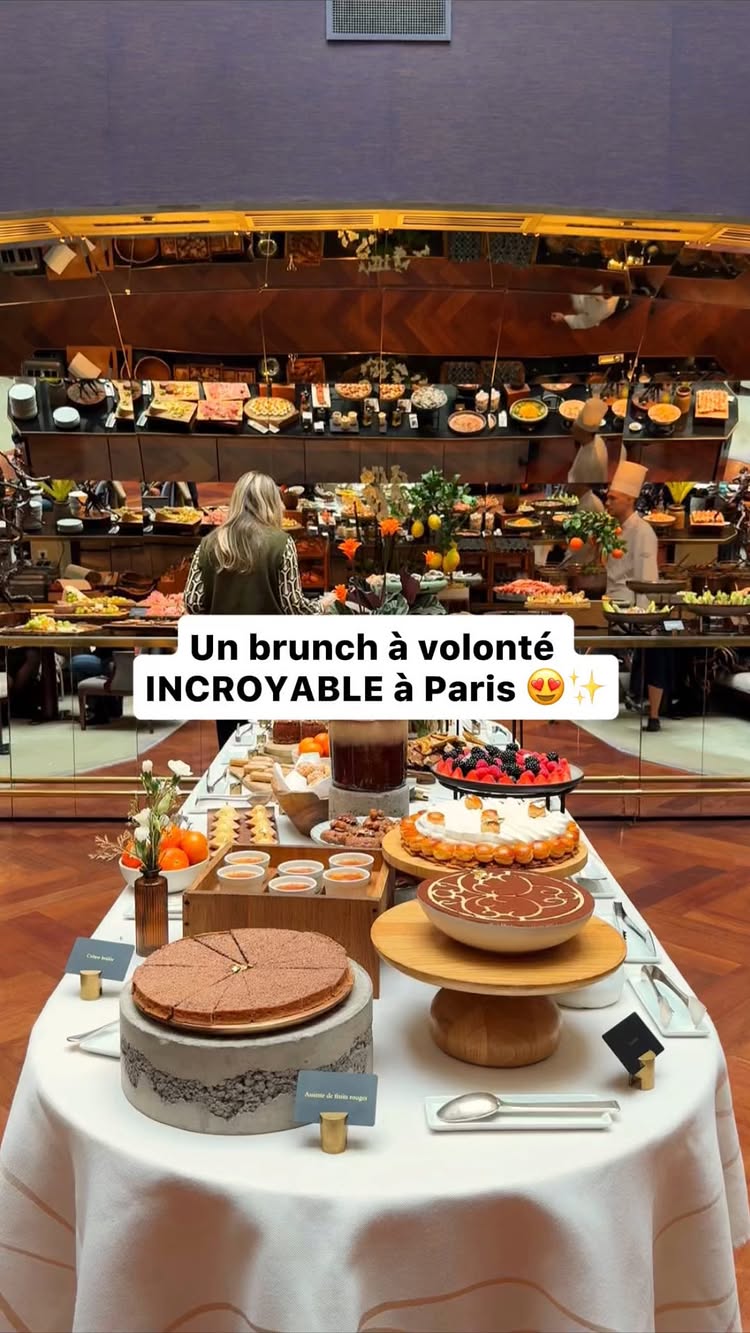 The cover image shows a brunch buffet with a woman standing in front of it. The buffet is set up on a long table with various food items beautifully arranged. In the foreground, there is a table set up with multiple desserts. The overall composition suggests a high-end dining experience with a focus on food presentation and ambiance.