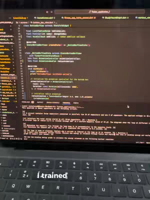 A dark cover image showing a laptop keyboard, with code displayed on the screen and the overlaid text 'trained'.