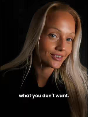 A woman with blonde hair looks towards the camera, smiling slightly. She is against a dark background, making the face the most prominent element. Below her, overlaid white text reads "what you don't want."