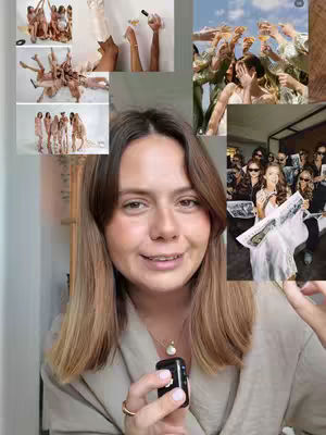 A woman with long brown hair, wearing a light-colored top, smiles directly at the camera while holding a small black device. The background is a collage of several images related to a wedding party. The primary image behind the woman includes several women raising glasses.