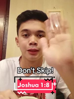 A young man is centered in the frame, looking directly at the camera with a slight smile. His right hand is raised, appearing as if it's waving hello, with the fingers spread apart. The background appears to be the interior a room with warm lighting, and a framed picture hanging on the wall. The text overlay on the lower portion of the image says Don't Skip! and Joshua 1:8