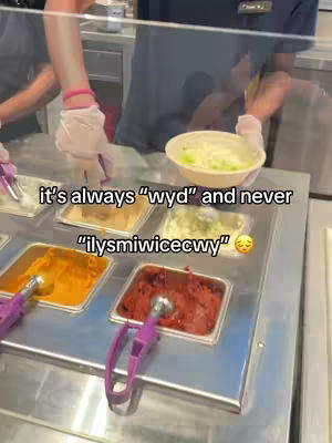 A person preparing a bowl of food behind a counter with various toppings. The text overlay adds commentary on dating.