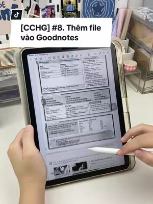 The image shows an iPad displaying a GoodNotes app, with a hand holding a stylus. The top of the screen has a white rectangle with Vietnamese text. The image is well-lit with a clean background.