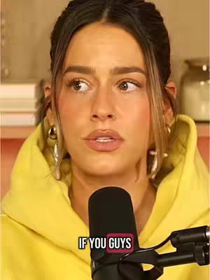 A young woman with light skin and brown hair looks slightly off-camera with a concerned expression. She is wearing a yellow hoodie, and a microphone is positioned below her face. The words "IF YOU GUYS" appear in a red box overlaid at the bottom of the image.