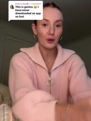 A woman with fair skin and light-colored hair is centered in the shot, set against a neutral background. She wears a pink, zip-up sweater and gold hoop earrings, and her expression is animated as if she is talking. A comment box overlays the top left corner with text.