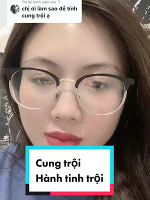 A close-up of a woman with glasses looking towards the camera. A text box at the bottom displays the words "cung troi" and "hanh tinh troi". Above her is a comment on a video.
