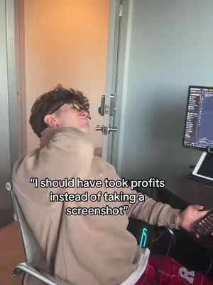 A young man wearing glasses and a hoodie leans back from his computer, looking exasperated. Text overlays the image stating, "I should have took profits instead of taking a screenshot."