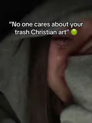 The cover image shows a close-up of a person's face and hand. The person appears to be in distress, with tears visible and the hand covering the lower portion of their face. The background is dark and blurry, with hints of grey fabric.