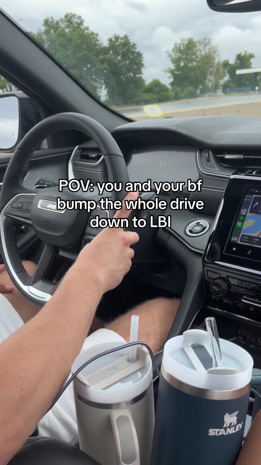 A first-person perspective shot from inside a car, likely a Jeep. The steering wheel and dashboard are in focus, with the driver's hands visible. The dashboard displays the car's speed and navigation information. The hook text is overlaid on the image.