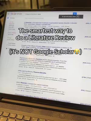 A laptop screen displaying a Google Scholar search. The screen is angled, with a keyboard visible in the foreground. Text overlays are added to describe the content, with the Google Scholar search results clearly visible.