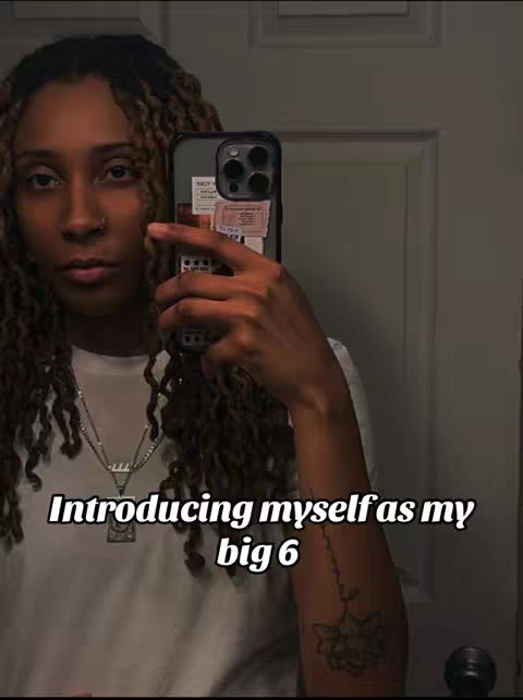 A selfie of a light-skinned person with long, styled hair, holding a phone up to a mirror, with text overlaid.