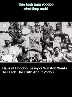 A black and white photograph depicts a group of people, primarily in traditional attire, seemingly engaged in a cultural or religious ceremony. The subjects are of African descent, with the central figure adorned with elaborate jewelry and a headdress, suggesting a position of importance. They are surrounded by others, some with serious expressions, in a close gathering. The overall lighting is muted, enhancing the solemn and historical feel. Text elements are overlaid, providing context and description.