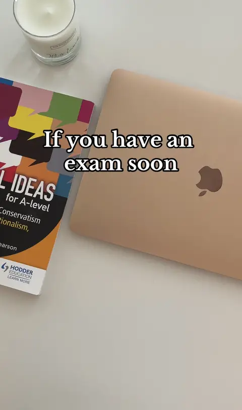 The image shows a laptop, a book, and a candle on a white surface, likely a desk. The laptop is slightly angled, showing the Apple logo. A book with a colorful cover and the title "IDEAS for A-level" is next to the laptop. A glass candle is in the upper left corner. Text overlayed on the image says 'If you have an exam soon'.