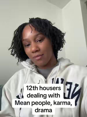 The cover image features a woman with dark, short, curly hair and a neutral expression. She is wearing a white hooded sweatshirt with black text. A white box at the bottom contains text about 12th house placements and related themes.