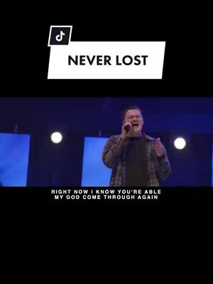 The image shows a man with a microphone in his hand singing in front of a stage with blue lighting. There is a logo in the top left corner for TikTok and a text box that says "Never Lost". At the bottom there is text that reads "RIGHT NOW I KNOW YOU'RE ABLE MY GOD COME THROUGH AGAIN".